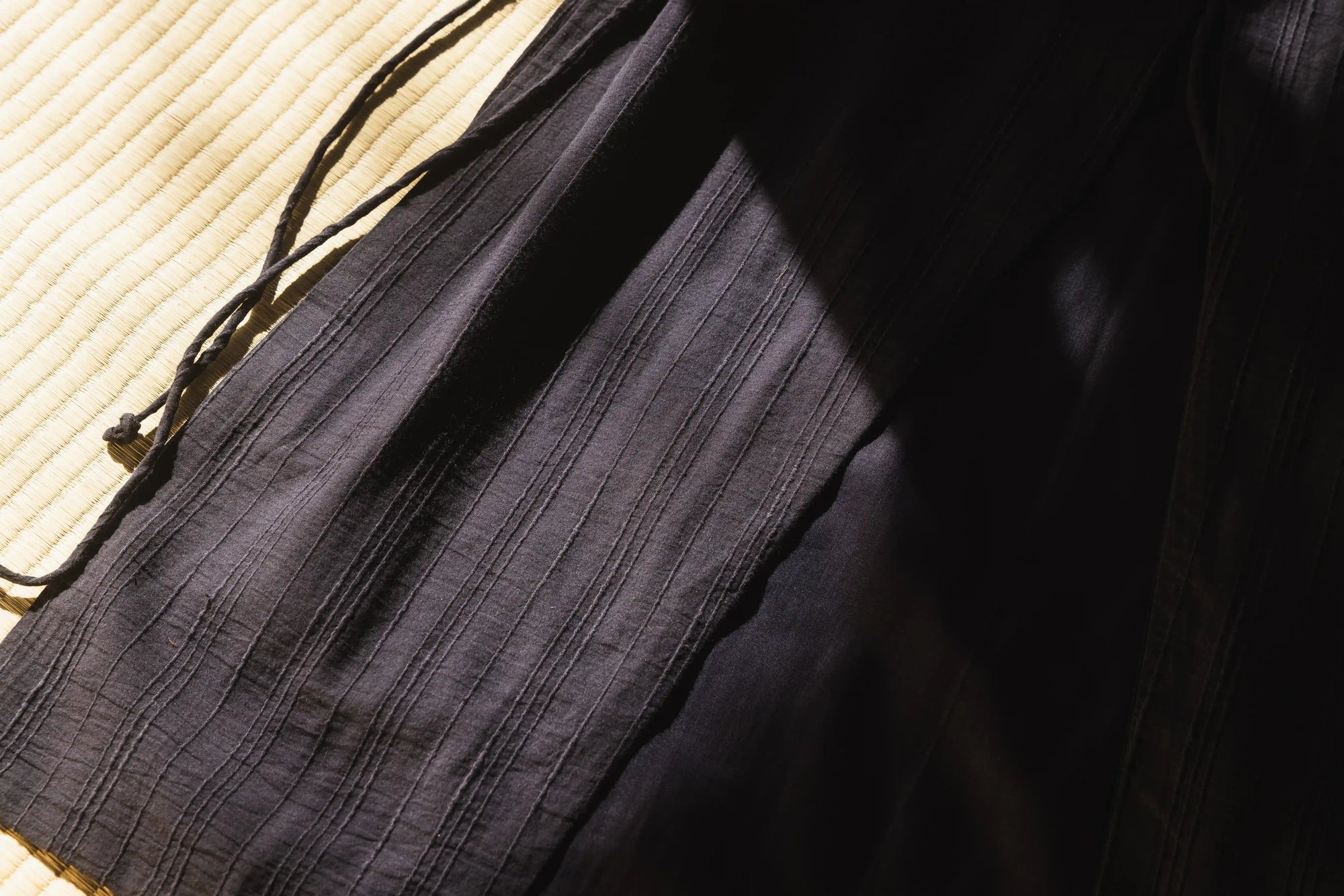 Close-up of a black fabric bag on a textured surface