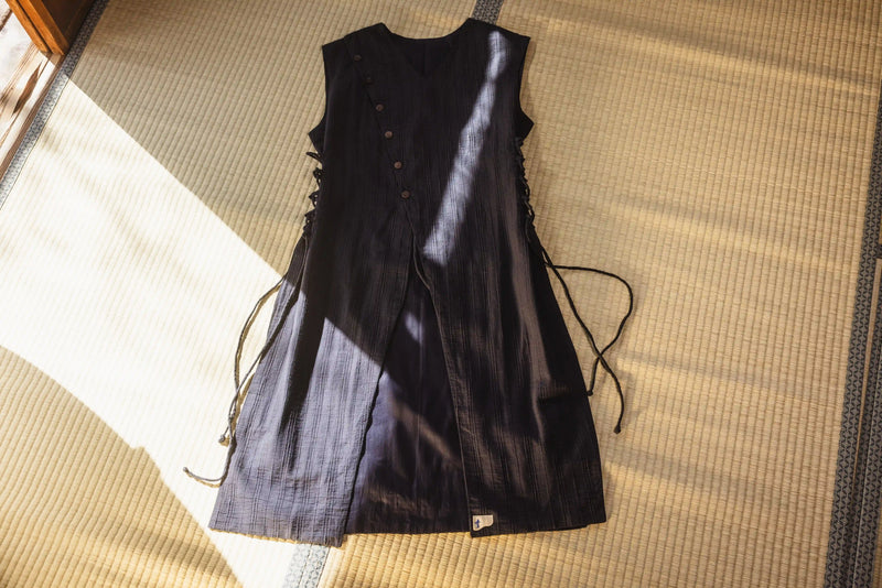 Black leather dress on a textured surface