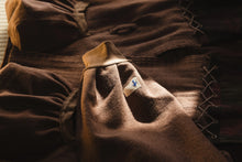Brown fabric with a logo on a wooden surface