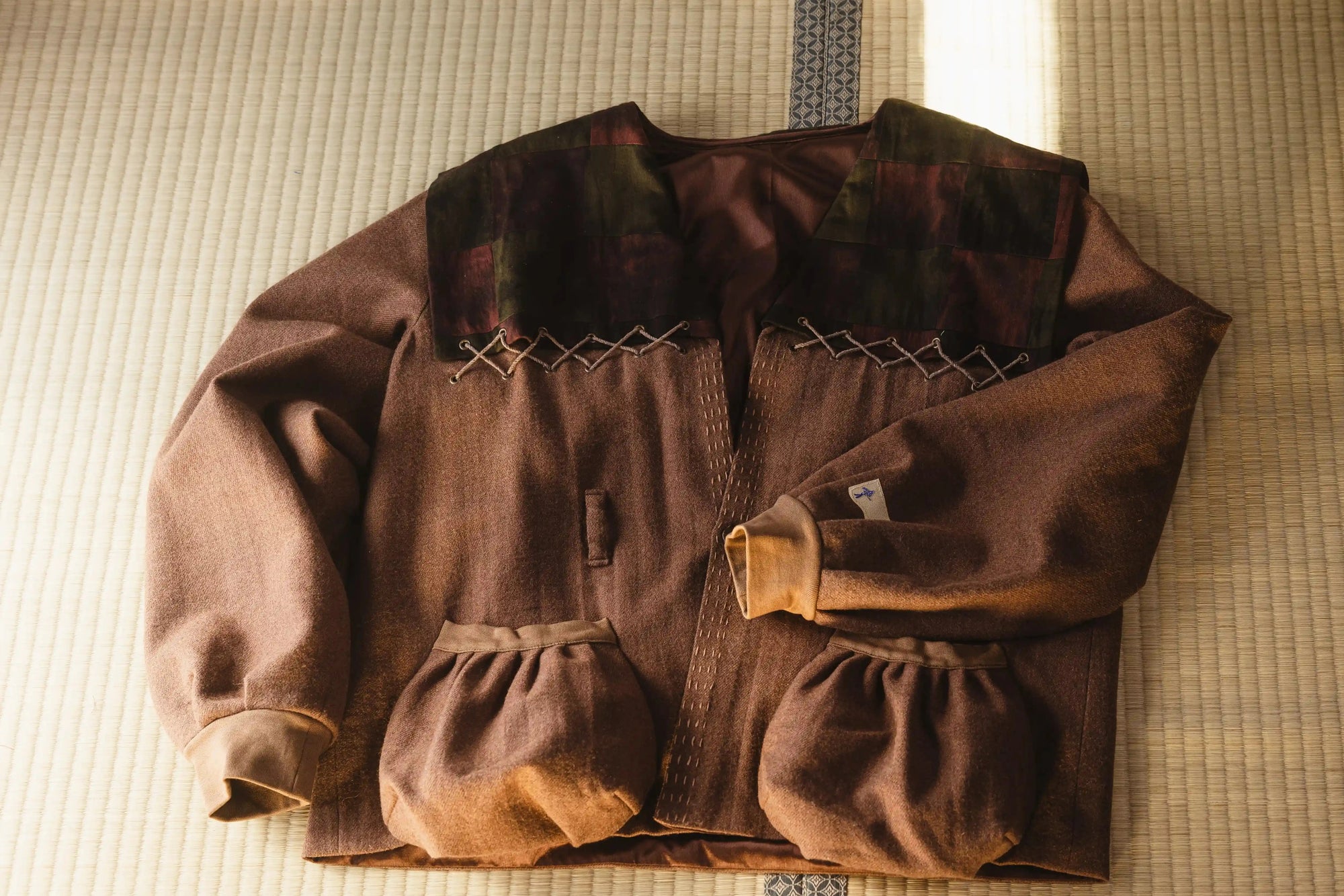 Brown jacket with quilted design on a textured surface