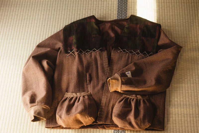 Brown jacket with quilted design on a textured surface