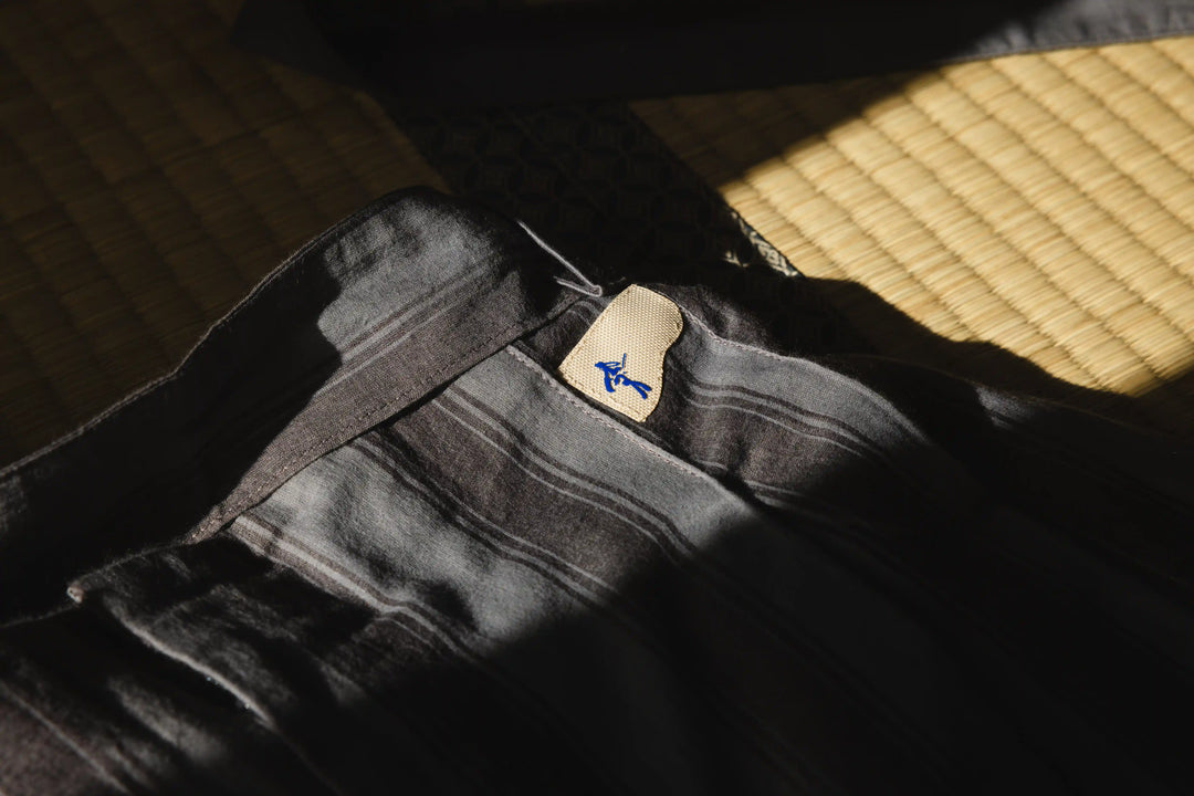 Black belt with a brand logo on a textured surface