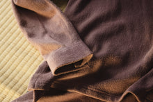 Brown towel on a textured surface