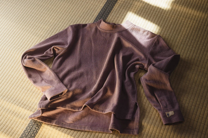 Brown sweatshirt on a textured surface