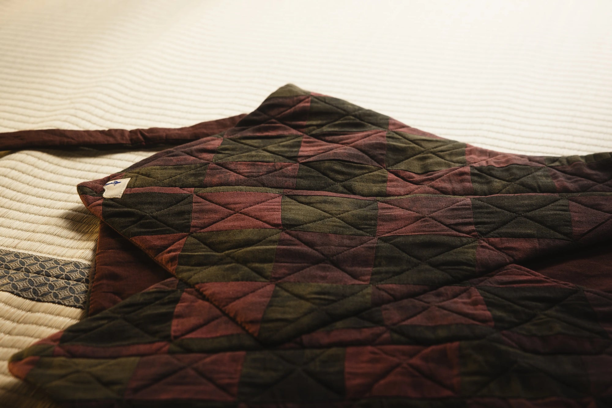 Quilted fabric with geometric pattern on a textured surface