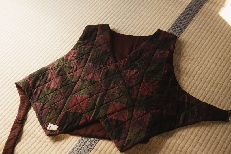 Quilted vest with a geometric pattern on a textured surface