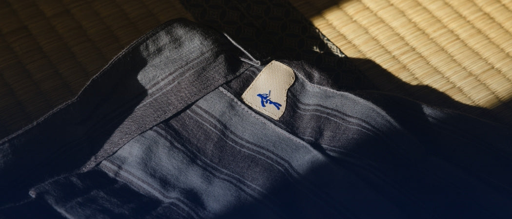 Close-up of a folded piece of clothing with a brand label on a textured surface